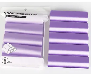 Detailed view of purple coreless drawstring disposable garbage bags for home use convenience.