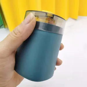 Detail view of the press-type plastic toothpick dispenser, showing the compact container.