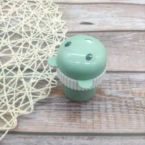 Close-up detail view of cute green cartoon bear plastic toothpick holder container.