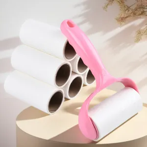 Lint roller with pink handle and refill rolls for clothes cleaning and dust removal detail.