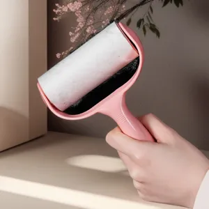 Pink lint roller with sticky paper refill and ergonomic handle for effortless pet hair removal.