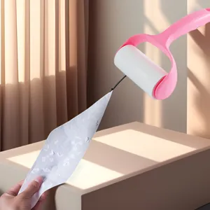 Tearable sticky lint roller with pink handle for clothes and pet hair removal cleaning tool.