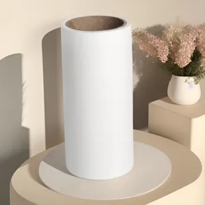 Adhesive lint roller refill roll detail view, tearable sticky paper for clothes cleaning.