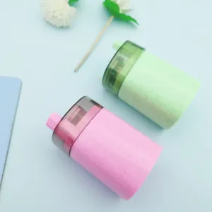 Automatic plastic toothpick holder detail showing pink and green press-type dispensers.