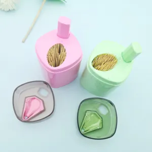 Automatic push-type plastic toothpick dispenser box holder container for home kitchen use.