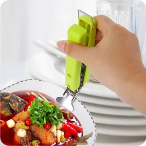 Stainless steel anti-scald bowl clip with green ergonomic handle for hot dishes plates.