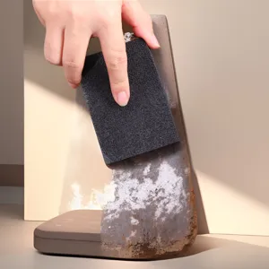 Close up view of carborundum sponge cleaning heavy rust on metal surface effectively.