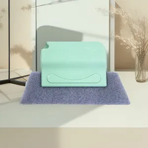 Detail view of the window groove cleaning brush with green handle and purple scouring pad.