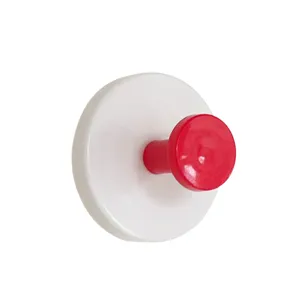 Detailed view of white suction cup wall hook with red knob for keys and small items.