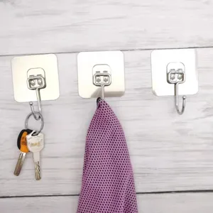 Stainless steel self-adhesive wall hooks detail view, showing versatile heavy-duty hanging use.