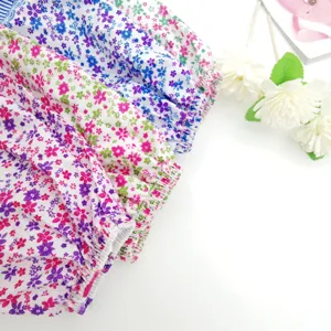 Detailed view of floral print oversleeves, showing elastic cuffs and vibrant fabric pattern.