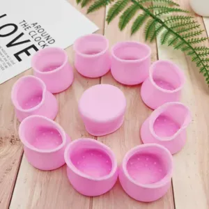 Detailed view of pink silicone chair leg protectors, showing non-slip dots and soft material.