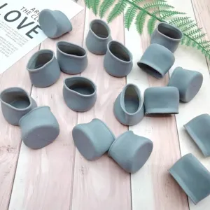 Detailed view of grey silicone chair leg caps, anti-slip furniture protectors for silent use.