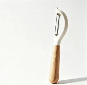 Stainless steel blade and wooden handle fruit peeler detail shot, ergonomic kitchen tool design.