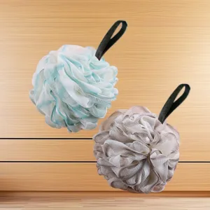 Close-up detail of soft mesh bath sponges in blue and brown with hanging loops for daily use.