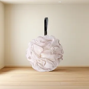 Close-up detail of a soft fluffy mesh bath sponge with a hanging strap for daily shower use.
