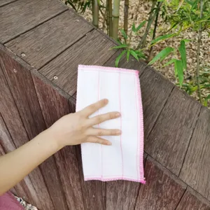Nahaufnahme des saugfähigen Küchentuchs mit weicher Textur und sauberer rosa Kantenverarbeitung.
