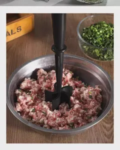 Manual meat chopper tool for kitchen, black plastic masher for mincing ground meat and food easily.