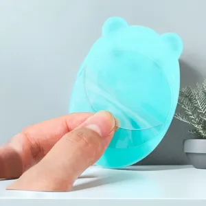 Detail view of the cute bear plug holder showing its transparent adhesive backing film.