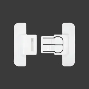 Detail view of the white child safety lock and catch for refrigerator doors and drawers securely.