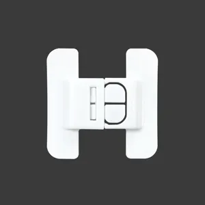 White plastic safety lock detail view, child proof lock mechanism for refrigerator doors.