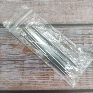 Stainless steel ear pick set detail showing various spoon and spring cleaning tools in a bag.