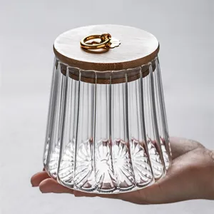 High borosilicate glass tea canister with wooden lid and sealed design for kitchen storage.