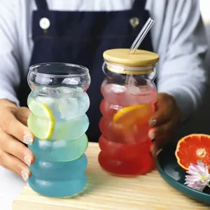 Clear ribbed glass cup set with wooden lid and straw, perfect for juice, milk, and daily home use.