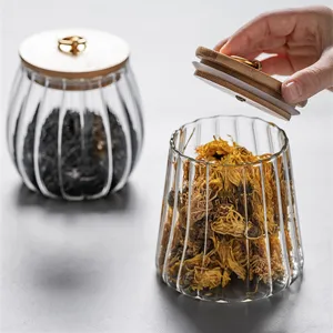 Ribbed glass storage jar with bamboo lid, airtight food container for kitchen organization.