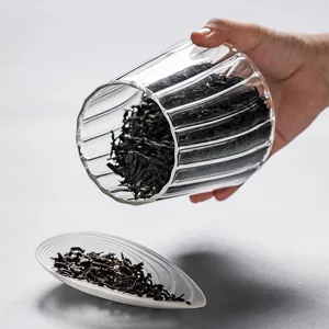 Clear glass tea canister with fluted design for kitchen food storage and home organization.