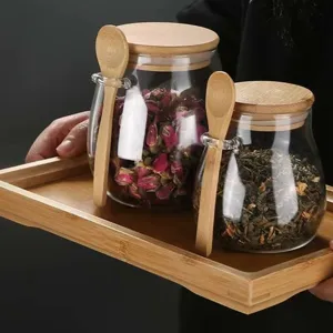Transparante glazen thee pot met houten deksel en lepel set, ideaal voor het bewaren van losse thee.