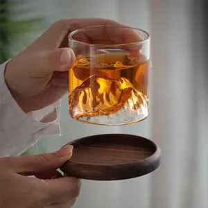 Borosilicate glass mountain view whiskey cup with wooden coaster for home and office use.