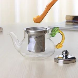Théière en verre résistant à la chaleur avec infuseur en inox et poignée dragon pour thé en vrac.