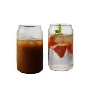 Clear glass cups with can shape, ideal for juice, iced coffee, and refreshing beverages.