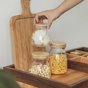 Clear glass storage jar with bamboo lid, ideal for kitchen grains, tea, and dry food organization.