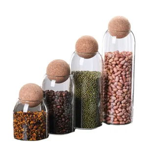 Glass storage jars with spherical cork lids set of four kitchen food canisters for dry goods.