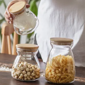 Glass storage jar with bamboo lid for kitchen dry goods, tea, and grains storage container.