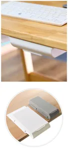 Under desk drawer detail showing white and grey adhesive storage boxes mounted neatly.