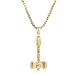 Detailed close-up view of a gold-colored Thor hammer pendant necklace with rune design.
