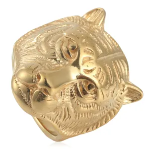 Detailed closeup view of the bold gold tiger head ring design in solid titanium steel.