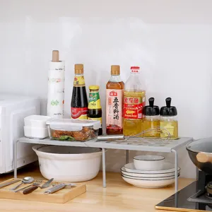 Kitchen expandable storage shelf detail showing sturdy structure and neat organization.