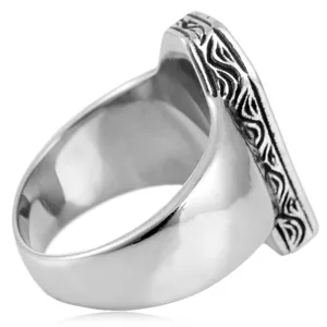 Detailed view of men retro stainless steel ring with carved pattern, high polished metal texture.