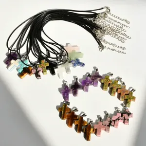 Natural stone cross pendant necklaces set with black leather cords, top view display.