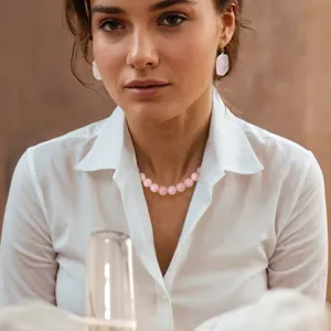 Stunning pink natural stone bead necklace and matching earrings set elegantly worn by a model.