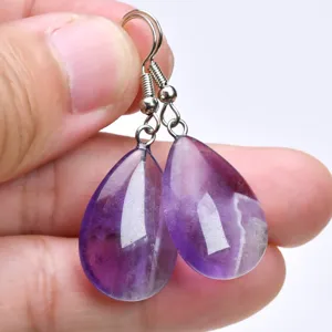 Detailed close-up of natural purple amethyst teardrop earrings with metal hooks.