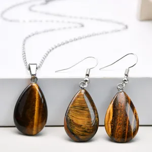 Natural tiger eye teardrop pendant necklace and matching earrings set detail jewelry display.
