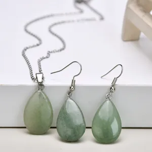 Green teardrop stone pendant necklace and earrings set detailed showcase closeup display.
