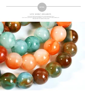 Primo piano dettagliato di bracciale con perle rotonde in finta giada e agata, finitura lucida.