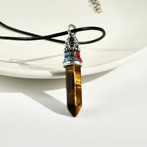 Natural tiger eye stone hexagonal pillar pendant with black cord necklace detail view.