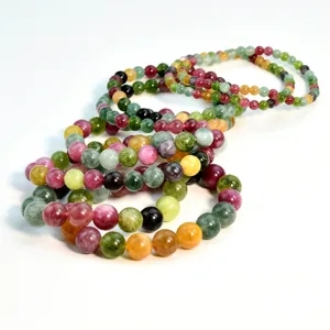 Colorful tourmaline beaded bracelet detail shot, vibrant gemstone jewelry stacking display.